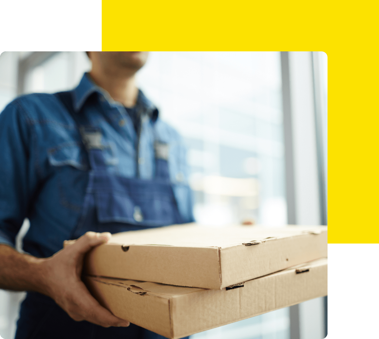 A man holding two pizza boxes